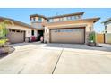 Three car garage with decorative stone features and covered front porch at 3925 E Vallejo Dr, Gilbert, AZ 85298