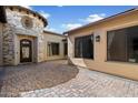 Charming courtyard with stone accents, elegant entryway, and neutral color palette at 4023 E Minton Cir, Mesa, AZ 85215