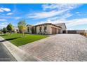 Spacious home features a wide driveway, three-car garage, and well-maintained turf and landscaping at 4023 E Minton Cir, Mesa, AZ 85215