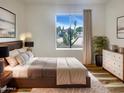 Comfortable bedroom with a queen bed, modern decor, and views of desert landscaping at 4111 W Desert Cove Ave, Phoenix, AZ 85029