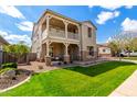 Attractive two-story home with a balcony, stone accents, a manicured lawn and attached garage at 4237 E Sierra Madre Ave, Gilbert, AZ 85296