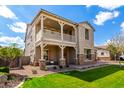 Attractive two-story home with a balcony, stone accents, a manicured lawn and attached garage at 4237 E Sierra Madre Ave, Gilbert, AZ 85296
