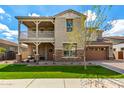 Charming two-story home featuring a balcony, stone accents, a well-manicured lawn and an attached garage at 4237 E Sierra Madre Ave, Gilbert, AZ 85296