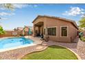 Private backyard featuring a sparkling pool, lush turf, and ample patio space for entertaining at 4630 E Mountain Vista Dr, Phoenix, AZ 85048