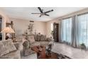 Inviting living room with tiled flooring, neutral paint, and comfortable seating at 4838 E Calypso Ave, Mesa, AZ 85206