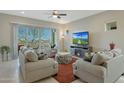 Comfortable living room with plush seating, a ceiling fan, and a sliding glass door at 5195 N 207Th Dr, Buckeye, AZ 85396