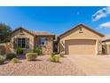 Charming single-story home featuring a stone facade, low-maintenance landscaping, and a two-car garage at 520 S 196Th Dr, Buckeye, AZ 85326