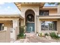Charming home featuring a stone and brick entrance with a beautiful arched doorway at 6340 N 34Th Pl, Paradise Valley, AZ 85253