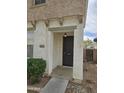 Front door of home featuring concrete walkway and exterior lighting at 6527 W Adams St, Phoenix, AZ 85043