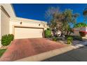 Charming home featuring a two-car garage, desert landscaping, and lovely curb appeal on a sunny day at 6701 N Scottsdale Rd # 15, Scottsdale, AZ 85250
