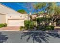 Charming home featuring a two-car garage, desert landscaping, and lovely curb appeal on a sunny day at 6701 N Scottsdale Rd # 15, Scottsdale, AZ 85250