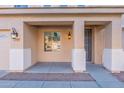 Inviting covered entryway featuring decorative lighting and a secure screen door, enhancing curb appeal and functionality at 7456 W Honeysuckle Dr, Peoria, AZ 85383