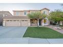 Beautiful two-story home with a three-car garage, easy-care artificial turf lawn, and mature trees in a quiet neighborhood at 7456 W Honeysuckle Dr, Peoria, AZ 85383