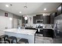 Well-equipped kitchen with granite countertops, stainless steel appliances, and a kitchen island with seating at 8445 N 61St Ln, Glendale, AZ 85302