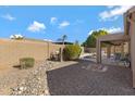 Spacious backyard with rock landscaping, walled for privacy, and covered patio by the pool at 8544 E Ocaso Ave, Mesa, AZ 85212