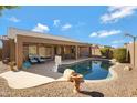 Inviting backyard pool with a covered patio, desert landscaping and plenty of space for outdoor relaxation at 8544 E Ocaso Ave, Mesa, AZ 85212