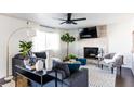 Bright living room with a gray fireplace, large sofa, and neutral-toned decor for a modern and inviting space at 13219 N 46Th Pl, Phoenix, AZ 85032