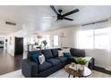 Cozy living room featuring a comfortable gray sofa, stylish pillows, and a bright window for natural light at 13219 N 46Th Pl, Phoenix, AZ 85032