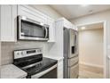 Modern kitchen equipped with stainless steel appliances, white cabinetry, and sleek countertops for a contemporary feel at 13611 N 98Th Ave # D, Sun City, AZ 85351