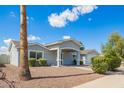 Inviting single-story house with desert landscaping and a covered entry, showcasing its charming exterior design at 13616 N 41 Pl, Phoenix, AZ 85032