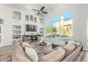 Modern living room with large windows, built-in shelving, and comfortable sectional sofa at 14808 E Miramonte Way, Fountain Hills, AZ 85268