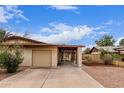 Charming single story home with desert landscaping, an attached garage and a covered carport at 1531 E El Parque Dr, Tempe, AZ 85282