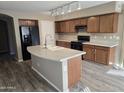 Modern kitchen with a spacious island, stylish countertops, and stainless steel appliances at 16317 N 152 Ave, Surprise, AZ 85374