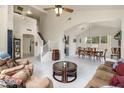 Bright and spacious living room featuring high ceilings, modern tile floors, and an open layout that flows into the dining area at 1648 S Faith --, Mesa, AZ 85209