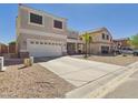 Two-story home featuring a two-car garage and concrete driveway at 1677 E Heather Dr, San Tan Valley, AZ 85140