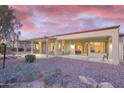 Expansive covered patio with ample seating, overlooking a meticulously landscaped yard, perfect for outdoor gatherings and relaxation at 16927 W Desert Blossom Way, Surprise, AZ 85387