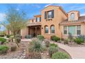 Beautiful home exterior with desert landscaping, a covered front porch and inviting curb appeal at 18552 N 94Th St, Scottsdale, AZ 85255