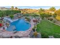 Stunning pool with waterslide, lounge area, and lush landscaping overlooking mountain views at 1922 E Saltsage Dr, Phoenix, AZ 85048