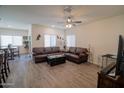 Spacious living room with a ceiling fan, and a comfortable leather sofa set at 2583 N Kenna Pl, Casa Grande, AZ 85122