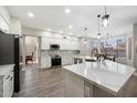 Bright kitchen featuring white cabinets, stainless steel appliances, and a breakfast bar with pendant lighting at 2702 S Beverly Pl, Chandler, AZ 85286