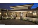 Striking stone facade with desert landscaping and inviting courtyard entrance at 30556 N Sage Dr, Peoria, AZ 85383