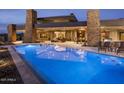 Sparkling swimming pool with lounge chairs overlooking the desert landscape and covered patio at 30556 N Sage Dr, Peoria, AZ 85383