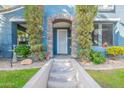 Inviting entryway with decorative stone archway and lush green landscaping and grass at 3432 E Jasper Dr, Gilbert, AZ 85296