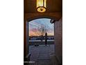Stunning desert sunset view framed by an arched doorway, highlighting the property's scenic location at 37509 N 7Th N St, Phoenix, AZ 85086