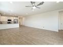 Open-concept living space showcasing tile floors and seamless flow into the kitchen at 4336 N 93Rd Dr, Phoenix, AZ 85037