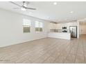 Bright living area featuring tile flooring and a modern ceiling fan at 4336 N 93Rd Dr, Phoenix, AZ 85037