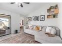 Cozy living room features plush sofa, stylish decor, and open access to a bedroom at 614 W Morrow Dr, Phoenix, AZ 85027