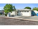 Single-story home with gravel landscaping, basketball hoop and an attached two-car garage at 6814 N 11Th St, Phoenix, AZ 85014