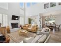 Inviting living room with a fireplace, clerestory windows, and comfortable seating arrangement at 9390 N 115Th St, Scottsdale, AZ 85259
