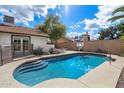 Refreshing backyard pool includes basketball hoop, stairs for easy access, and is surrounded by desert landscaping at 1002 E Grandview Rd, Phoenix, AZ 85022