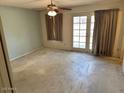 Bedroom featuring a ceiling fan and sliding glass doors to the backyard at 10250 N 65Th N Ave, Glendale, AZ 85302