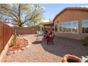 Private backyard featuring a fire pit, comfortable seating, and gravel landscaping at 10356 E Meandering Trail Ln, Gold Canyon, AZ 85118