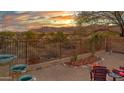 Relaxing backyard features a fire pit, comfortable seating, desert landscaping, and picturesque mountain views at 10356 E Meandering Trail Ln, Gold Canyon, AZ 85118