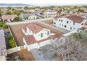 Aerial shot of a two-story home showing a red-tile roof and a large dirt-filled backyard at 12698 N 153Rd Ave, Surprise, AZ 85379