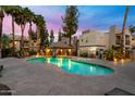 Stunning community pool with a hot tub, poolside lounge chairs, and mature palm trees at 14145 N 92Nd St # 2077, Scottsdale, AZ 85260