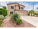 Landscaped front yard with mature shrubbery leads to this lovely two-story home with a three-car garage at 1567 S Western Skies Dr, Gilbert, AZ 85296